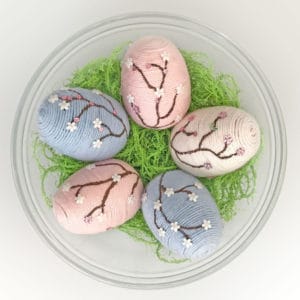 Eggs in bowl with decorative easter eggs