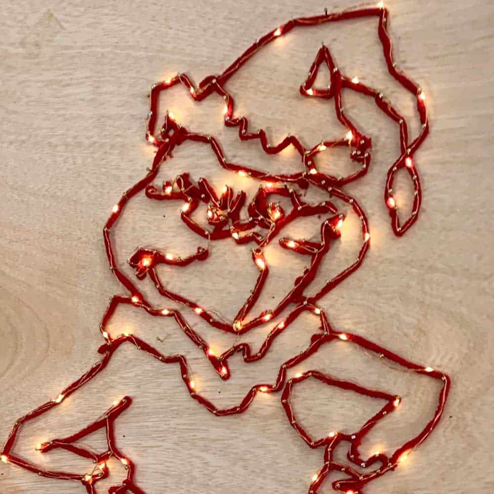 Lighted DIY Grinch String Art Decoration on Plywood
