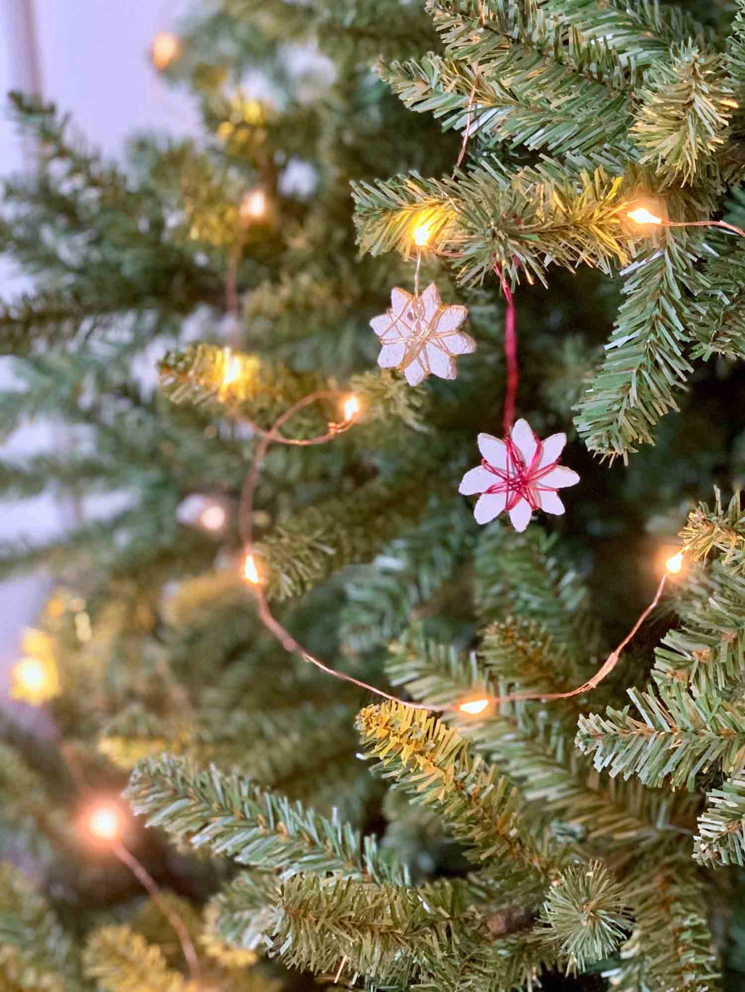 diy cement ornaments hanging on Christmas tree with lights