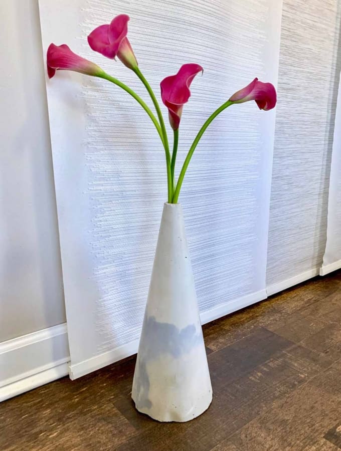 cone shaped cement vase with calla lillies