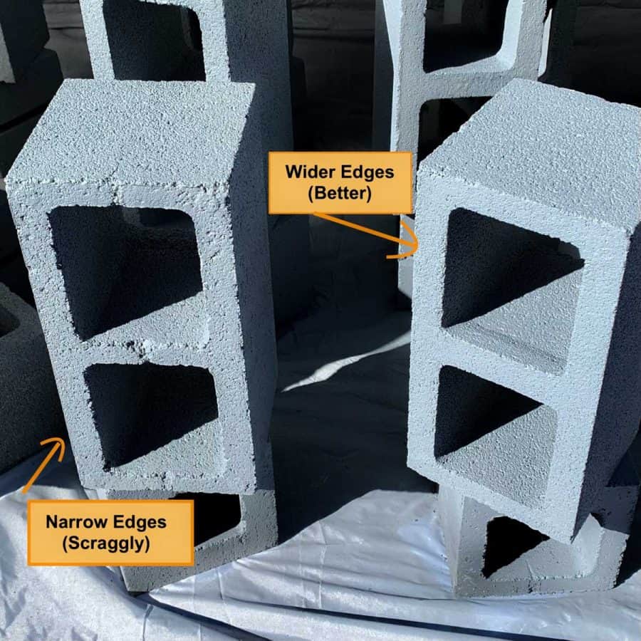 cinder blocks standing on ends with white primer on them