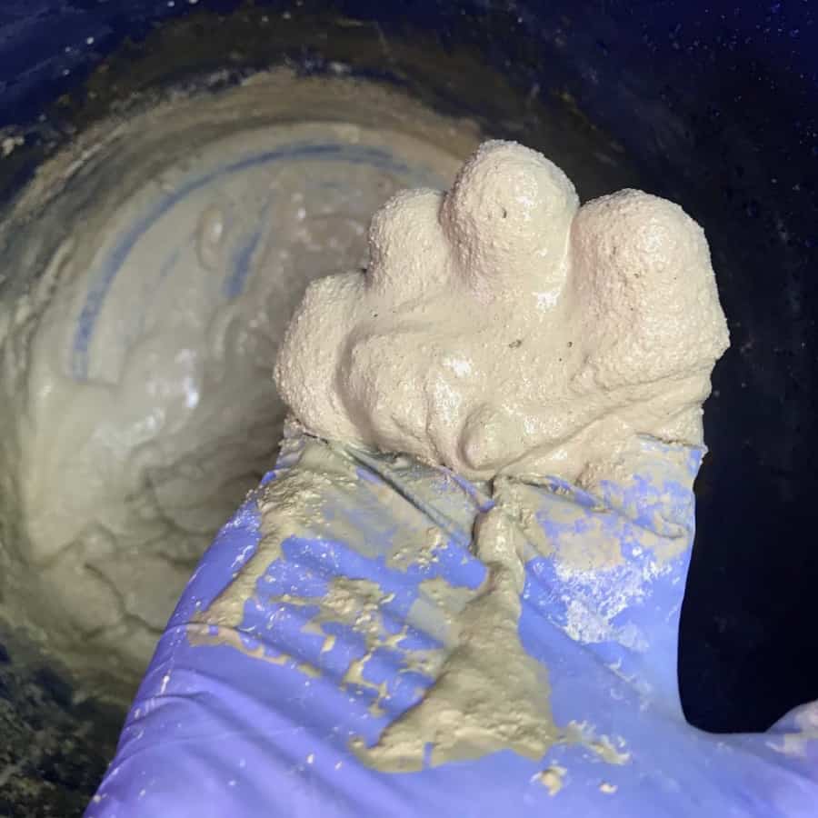 hand with glove for mixing concrete
