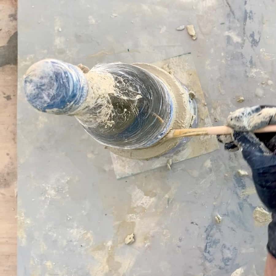 clean up cement on top of collar mold with brush