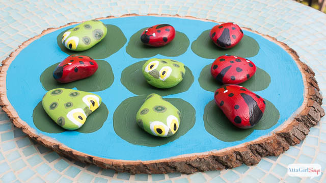 tic tac toe game on wood with ladybugs and frogs