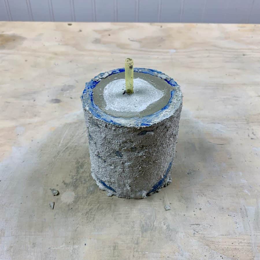 cement planter curing in mold with drainage straw inserted