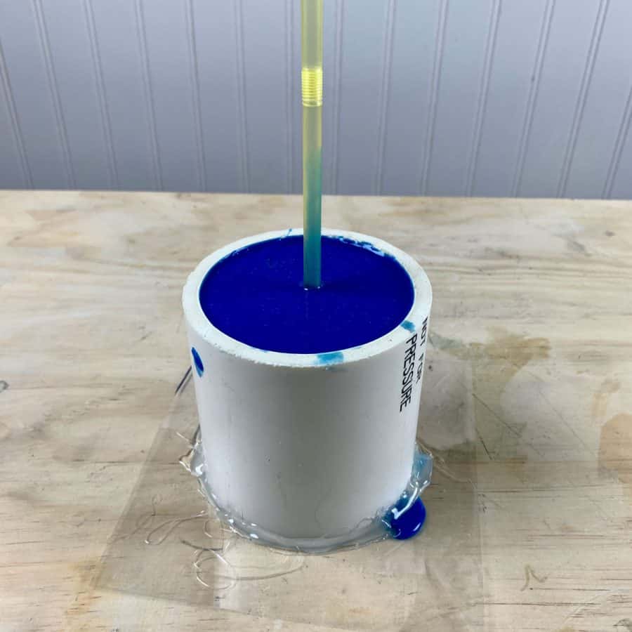 silicone poured for cement pot with drainage straw inserted