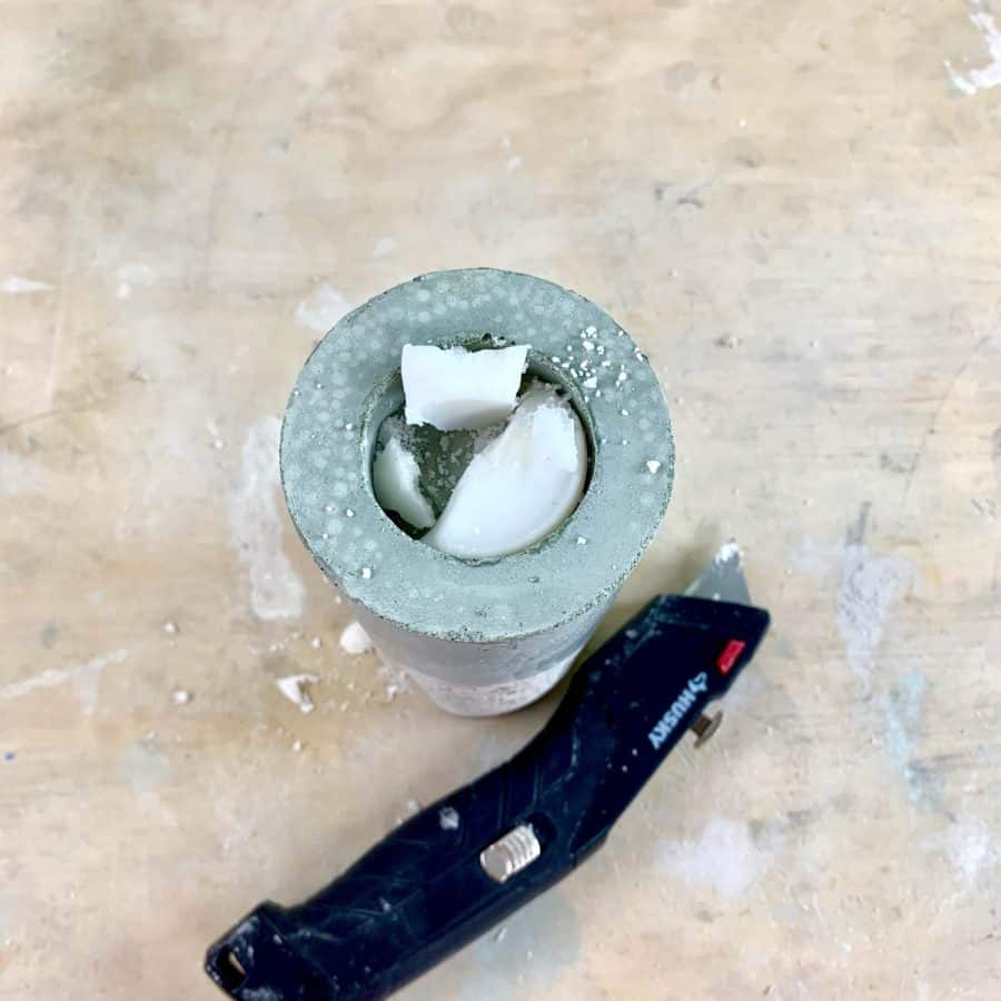 cutting out wax from cured concrete candle holder