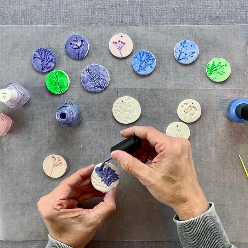 diy nature ornaments with nail polish brushing on top of clay