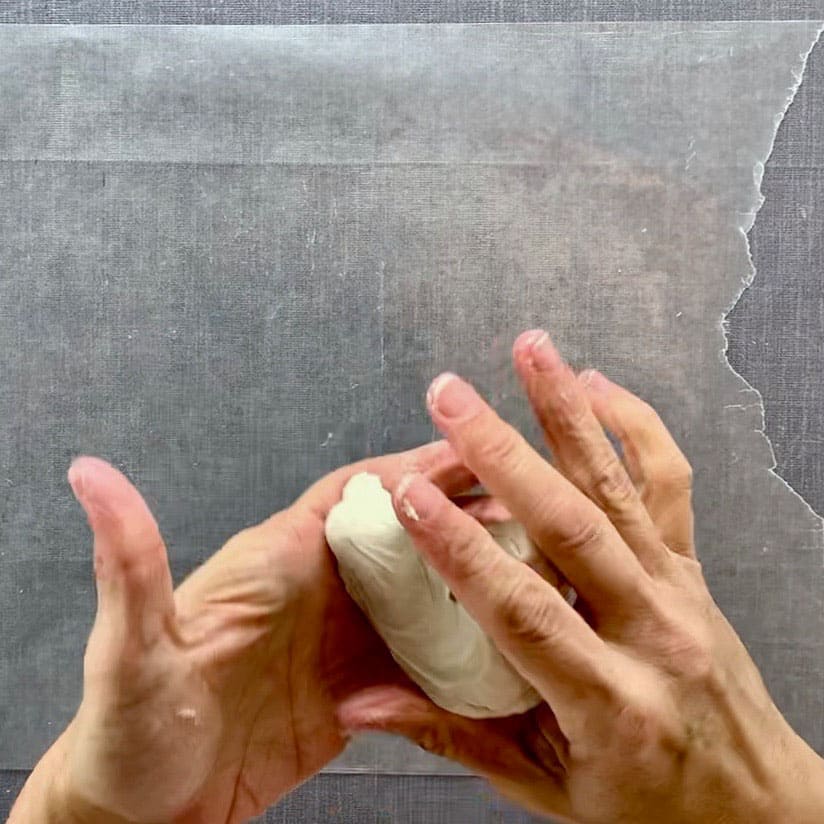 hands kneading air dry clay