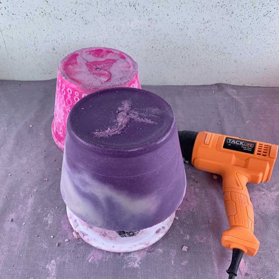 purple cement planter upside down with heat gun and outer mold removed