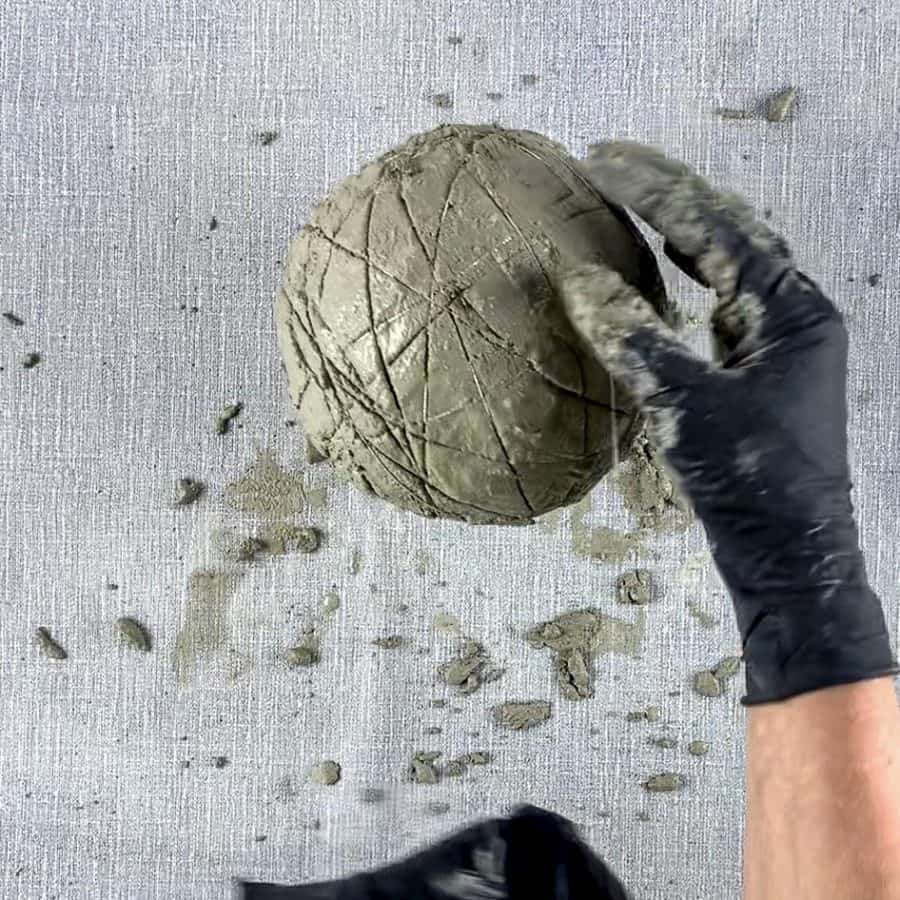 cement on balloon being wrapped with cord