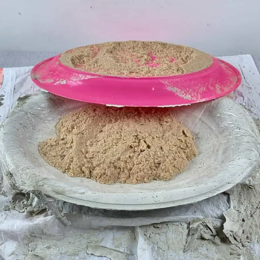 cured concrete on table, rightsize cup with sand inside and tray partially removed