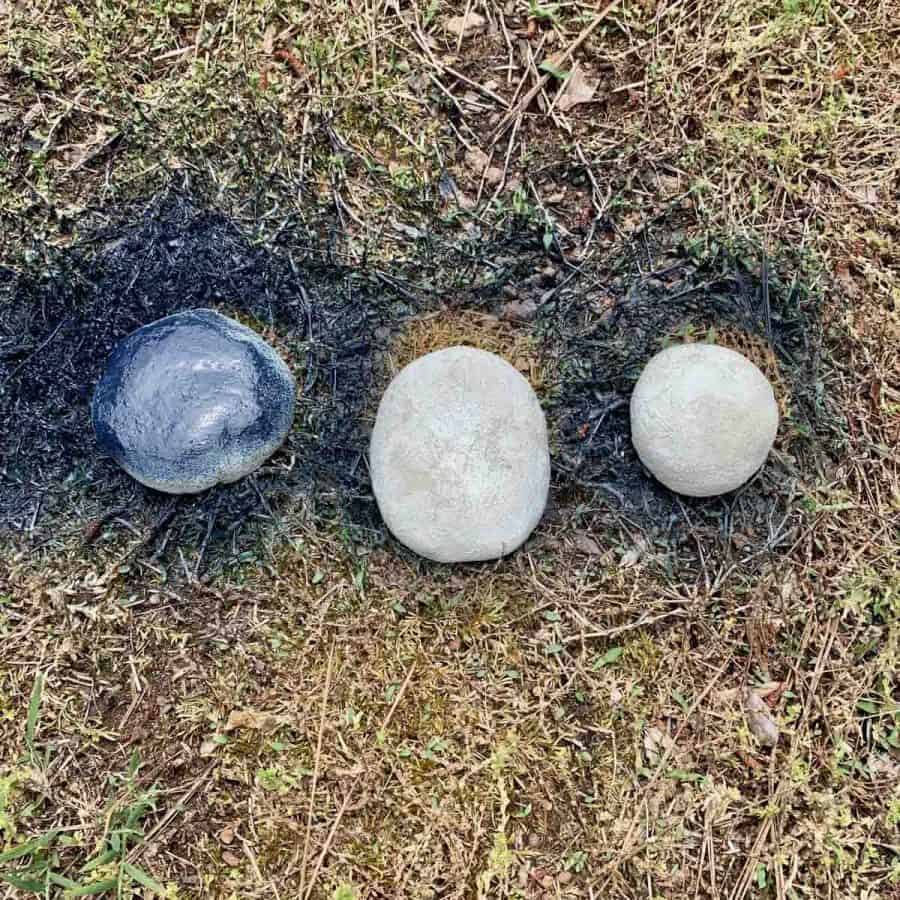 diy concrete stones on grass, being spray painted