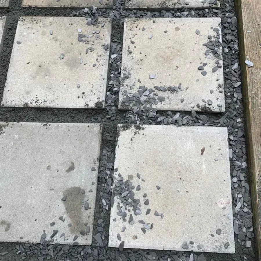 concrete paver patio stones with black marble chips in between and scattered on top
