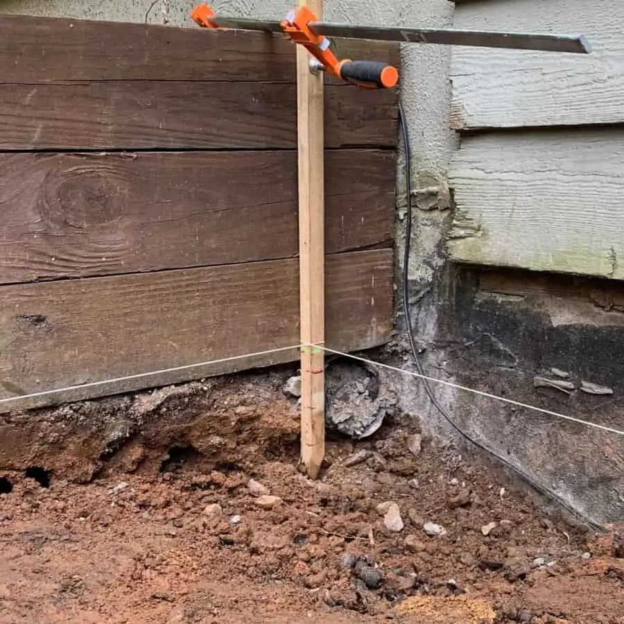yard stake clamped to timber