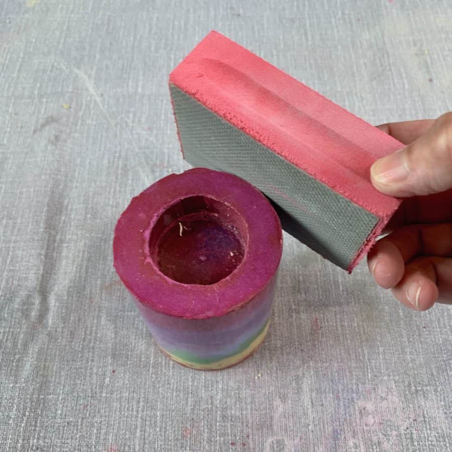 Concrete Candle Holder- diamond grit sanding sponge sanding top edge of candle holder.