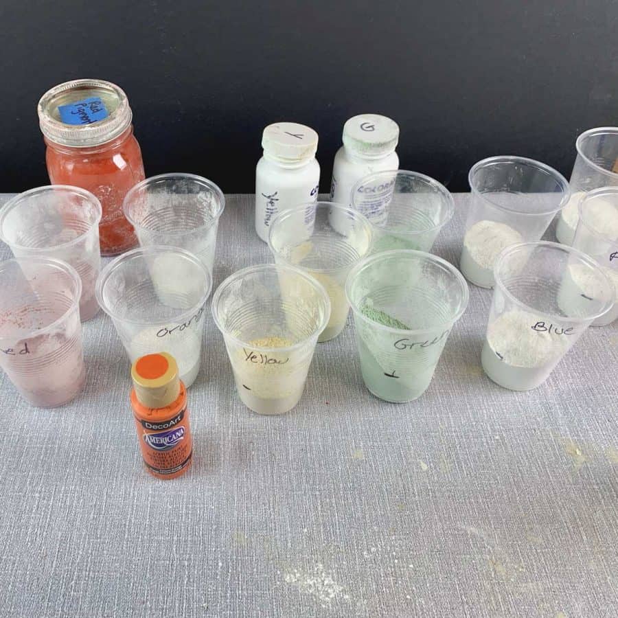Concrete Candle Holder- plastic cups with concrete mix and each has a different color from added pigment.