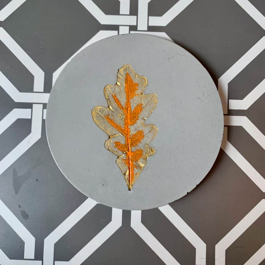 Concrete Coasters-beverage coaster with orange paint in middle, gold paint underneath