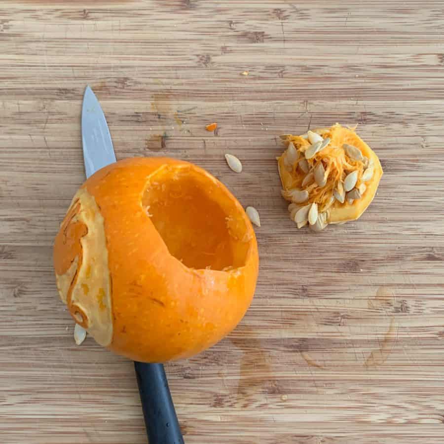 knife under pumpkin with bottom removed