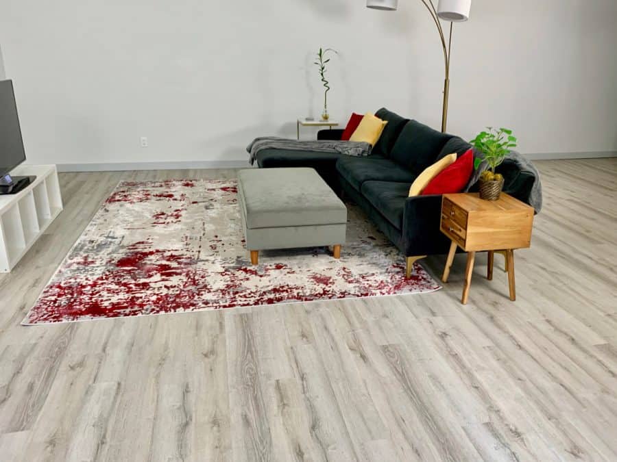 modern living room with leveled concrete floor underneath vinyl plant flooring