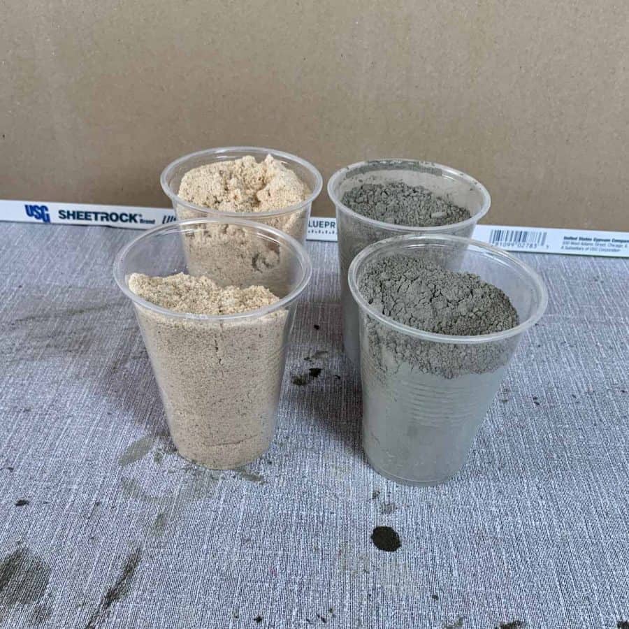 plastic cups measuring 2 parts sand and 2 parts cement