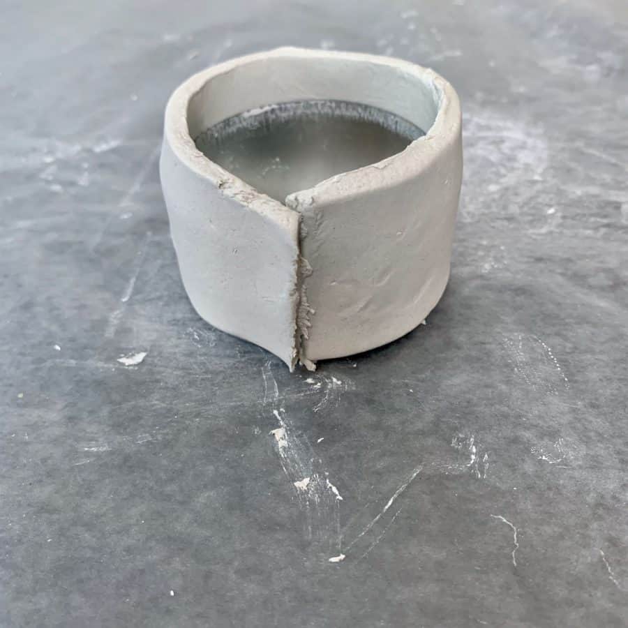 strip of clay shaped into ring with ends overlapping