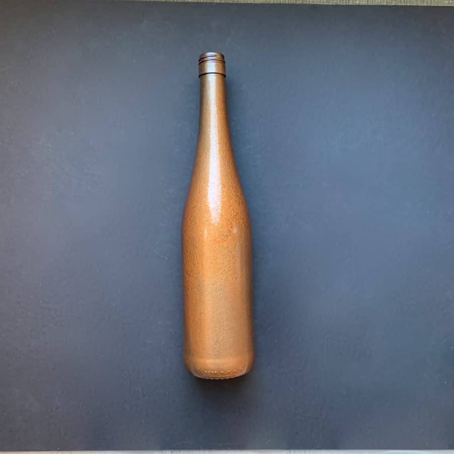 copper coated base coat on wine bottle
