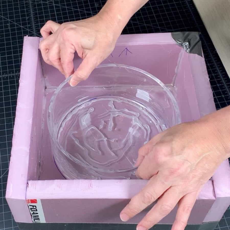placing glued bowl into silicone mold box