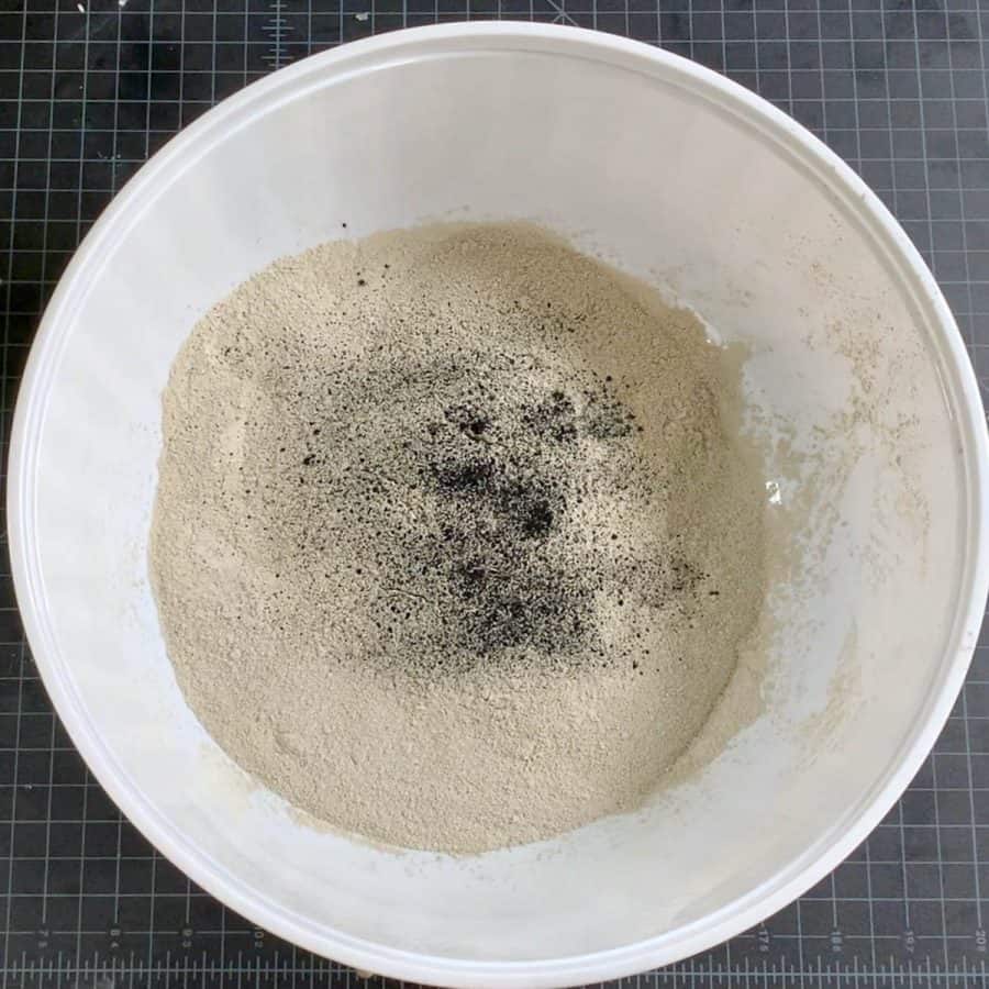 dry cement mix with black pigment sprinkled on top