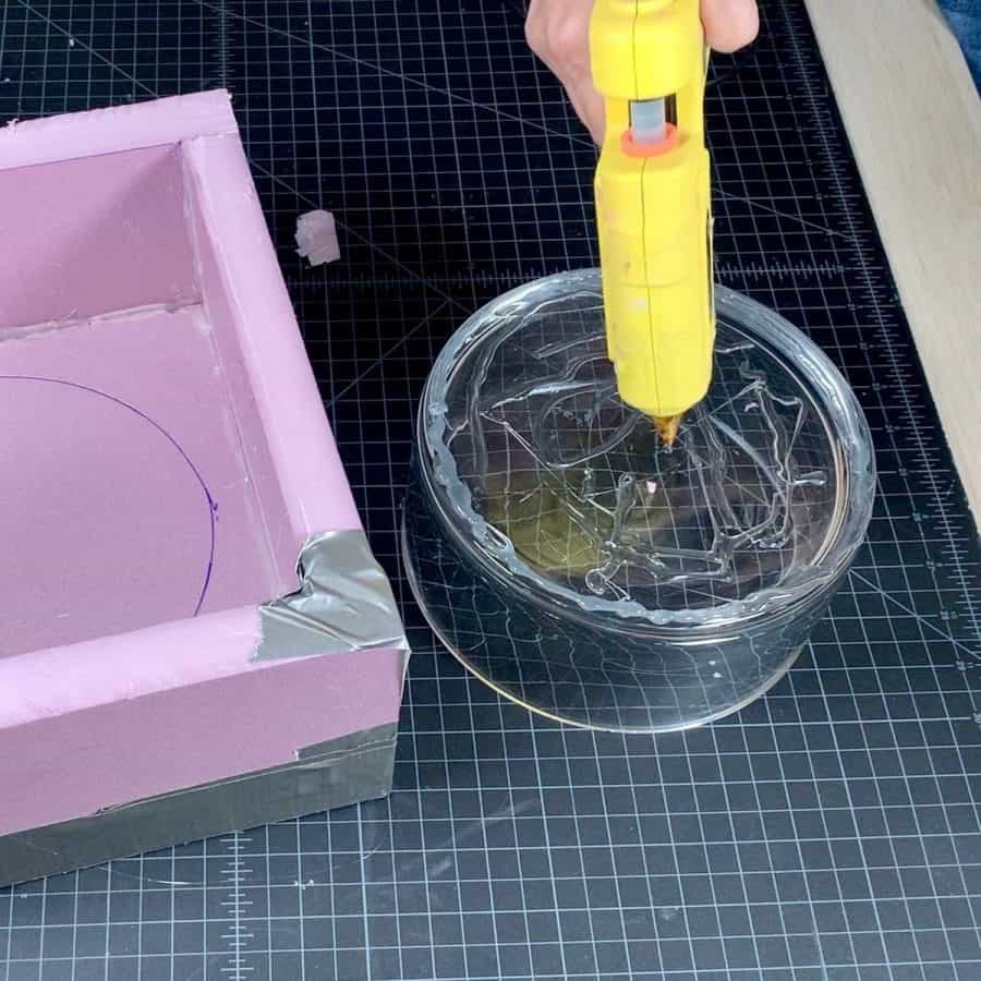 applying glue to bottom of glass bowl