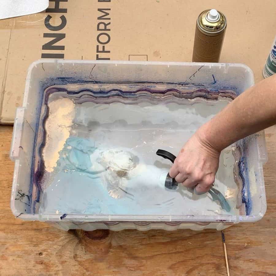 back side of vase grabbing hydro dip spray paint in water