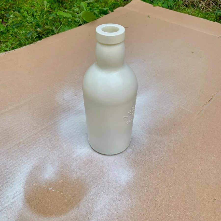 bottle with off-white spray paint base coat