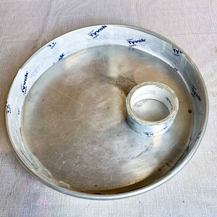 aluminum pan empty except roll of packing tape inside and inside edges are covered with tape.
