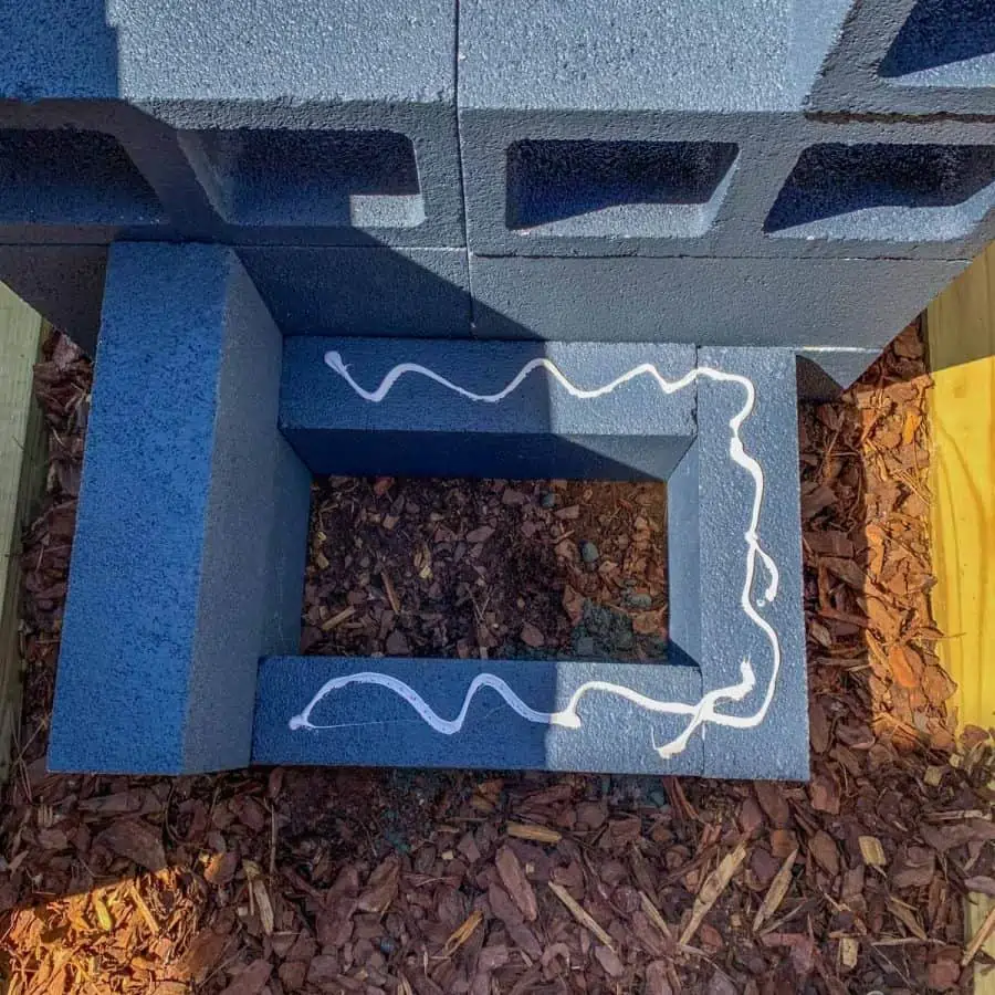 top view of concrete block planter box pieces with glue on bottom level