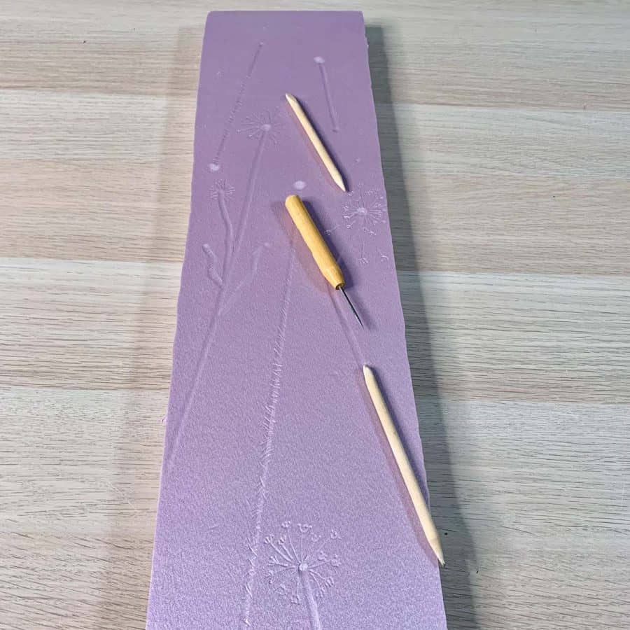 pink insulation board with pencil blending tools laying on top