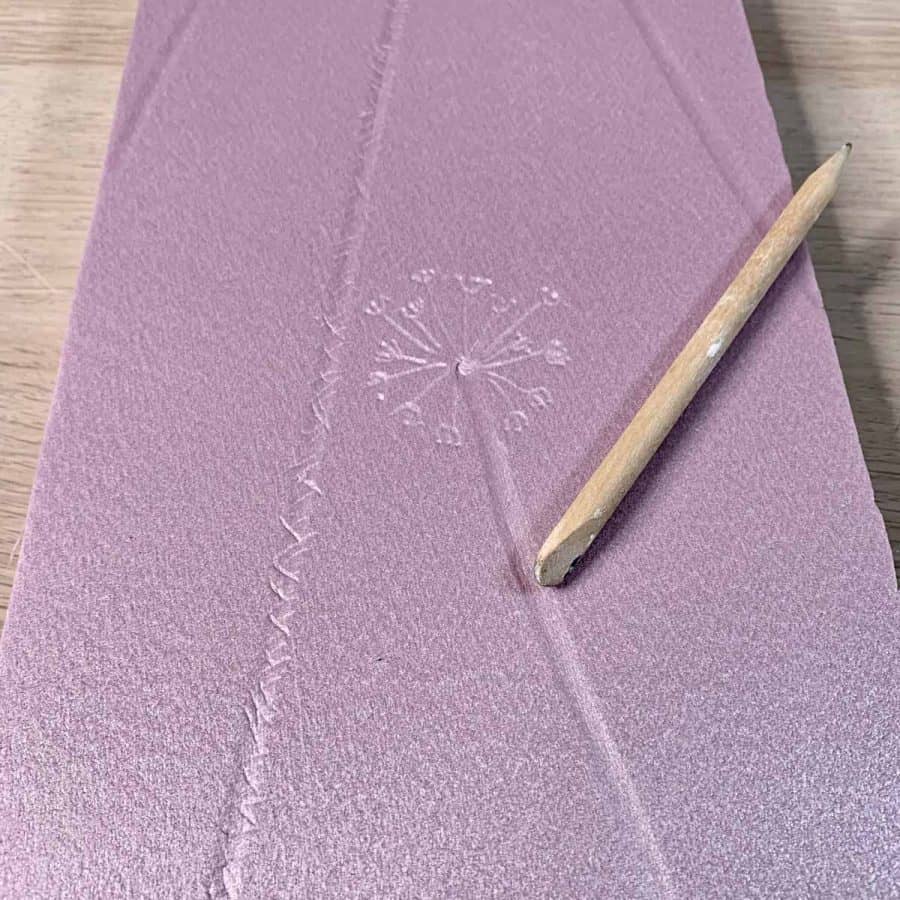 pink insulation board with dandelion design carved into it for stamped concrete pattern