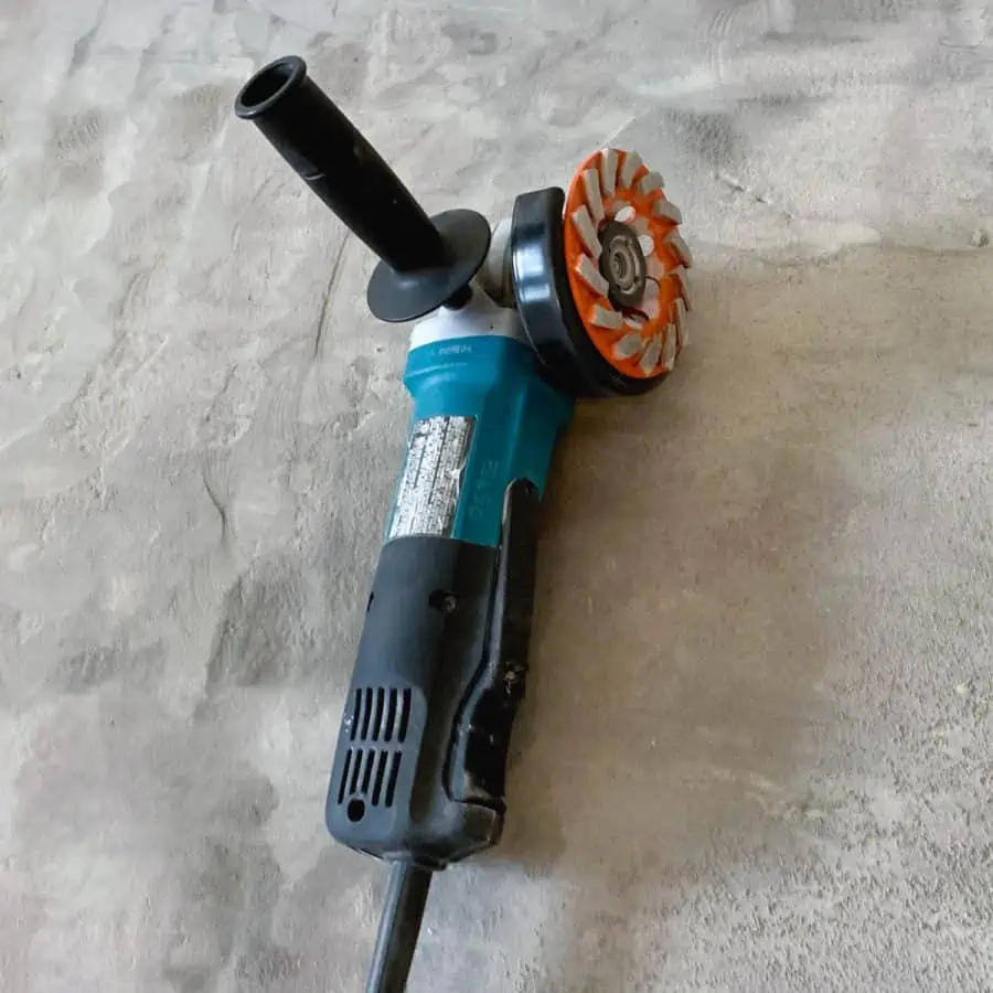 an angle grinder with diamond discs laying on a floor