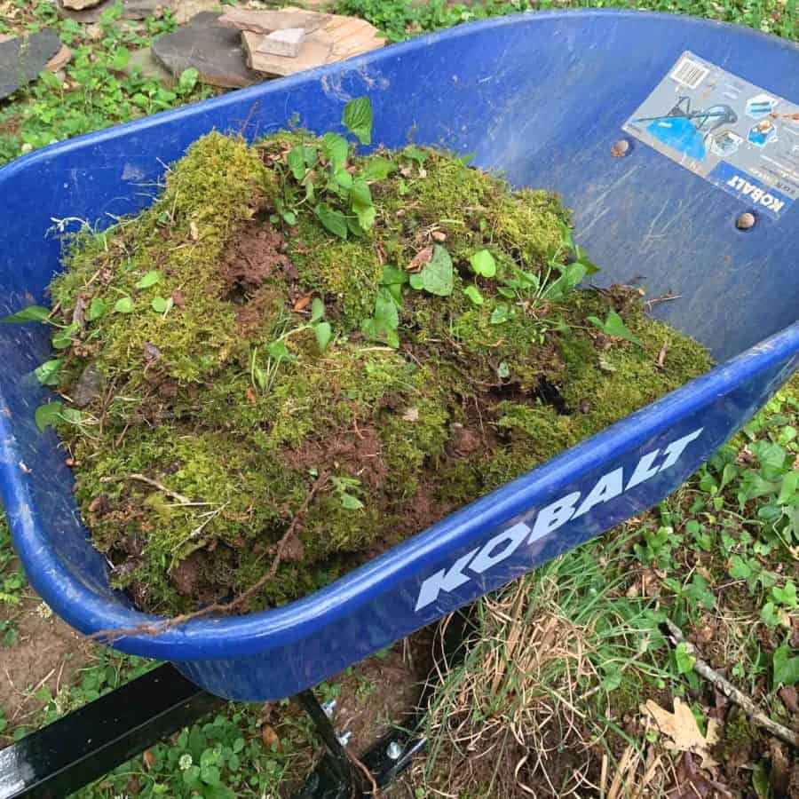 a wheelbarrow with layers of sodded patches of moss
