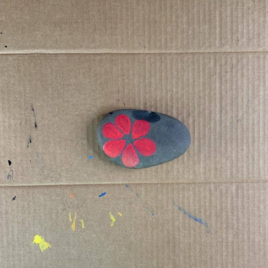 rock with red petals painted and evenly sized