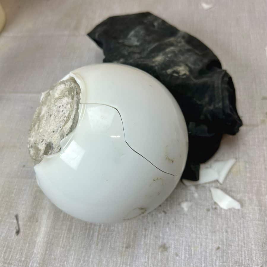 The plastic globe with a large crack line running down it.