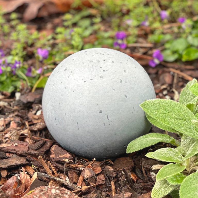 A DIY concrete sphere in the garden.