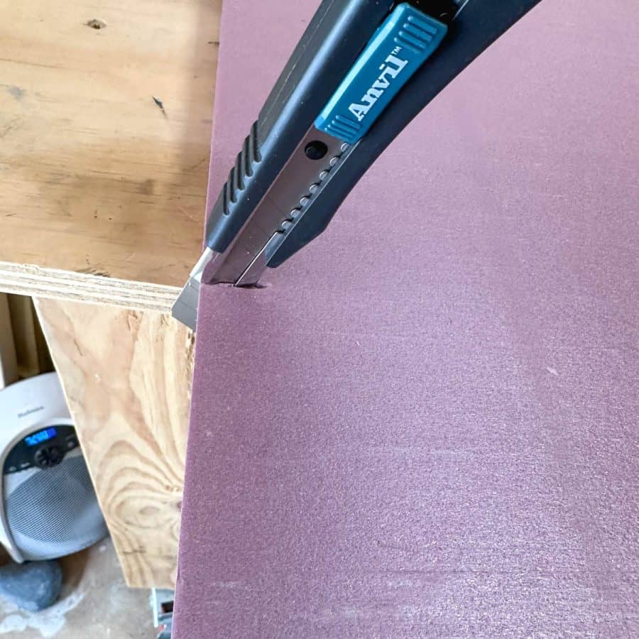 Razor utility knife cutting foam board base.