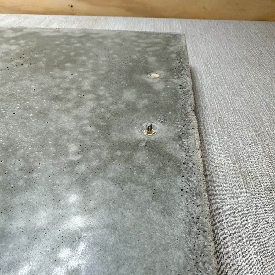 Tip of screw coming through the to of the DIY concrete tray.