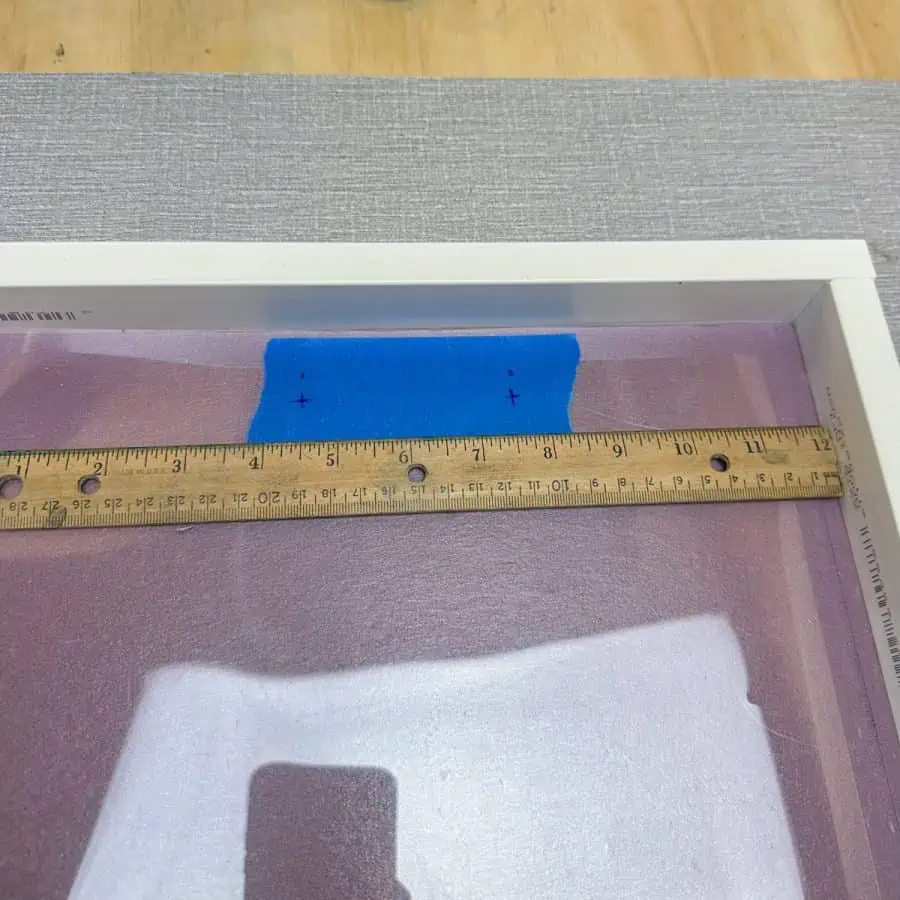 A ruler inside tray mold marking centers for handles.