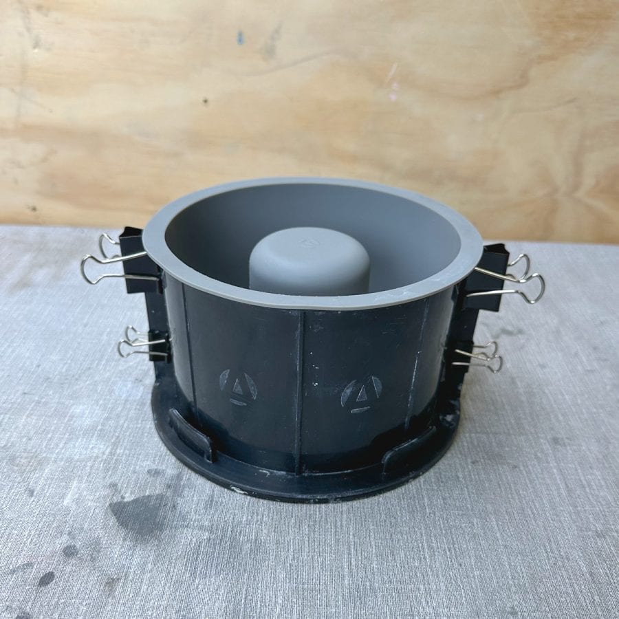 a concrete tabletop fire bowl silicone mold with binder clips attached