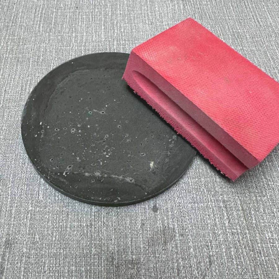 sanding made on top of cured concrete coaster.
