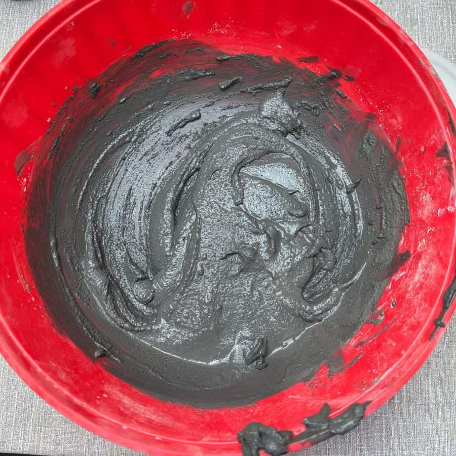 wet concrete mix with black pigment, in bowl.