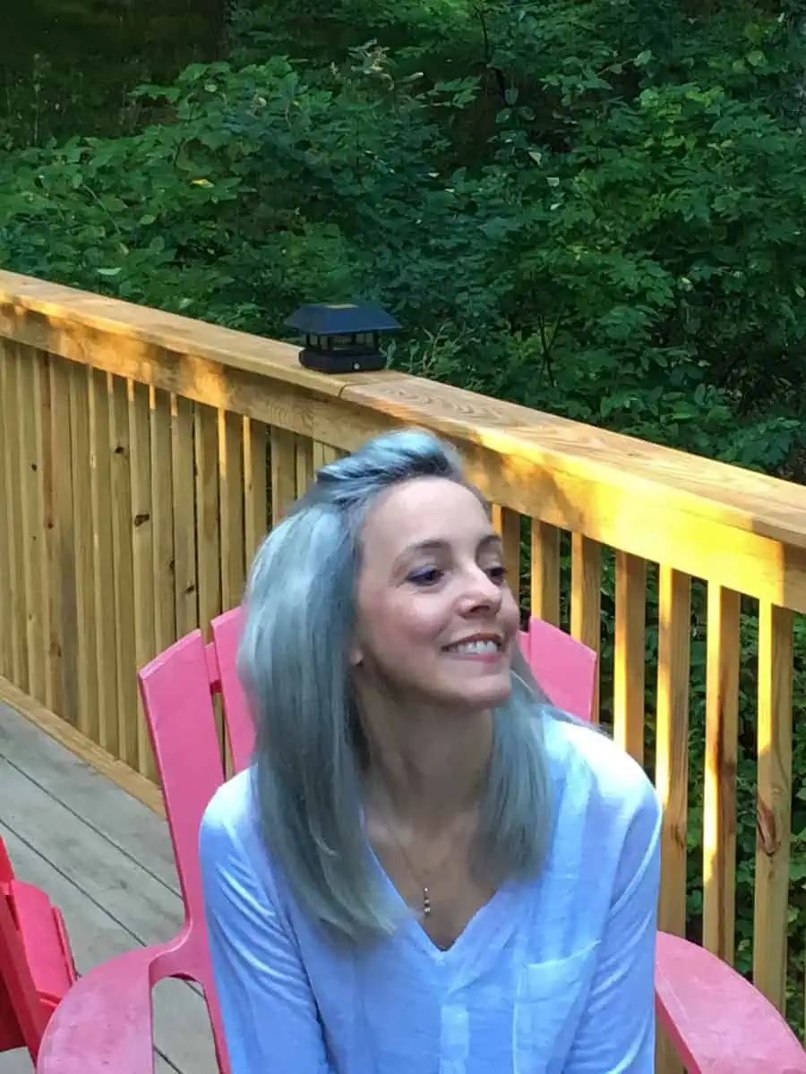 Pic of Artsy Pretty Plants blog author Ellen with artsy blue hair, sitting on a deck.