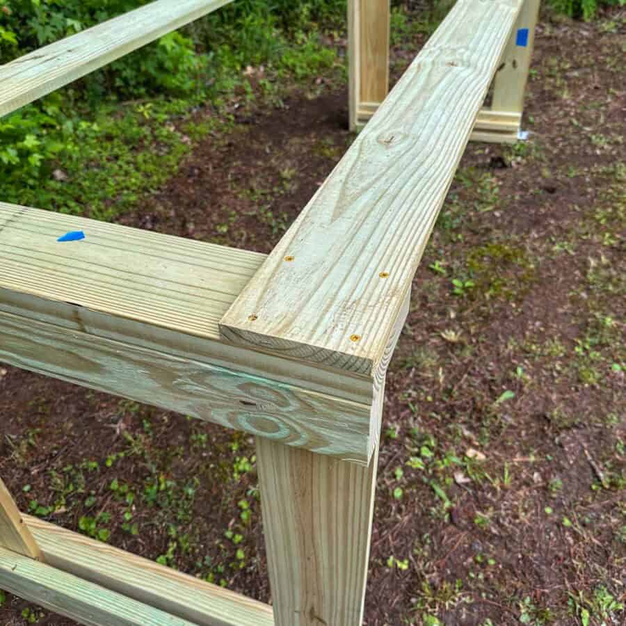 Close up of screwed corner where long boards join legs.